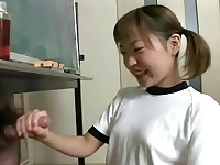 An Asian girl is drawing on a blackboard. Suddenly a guy appears behind it and she goes down on her knees to jerk him off. Then two new guys appear and she jerks them off too, making them both come.