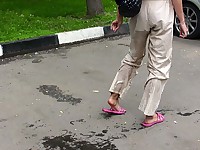 Amateur piss addict wets herself and leaves wet traces on the asphalt