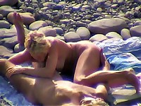Voluptuous blond sucks off her bf on a pebbly beach under spy control