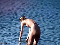 Voyeur fan spies on a beautiful naked lady as she chills on the beach